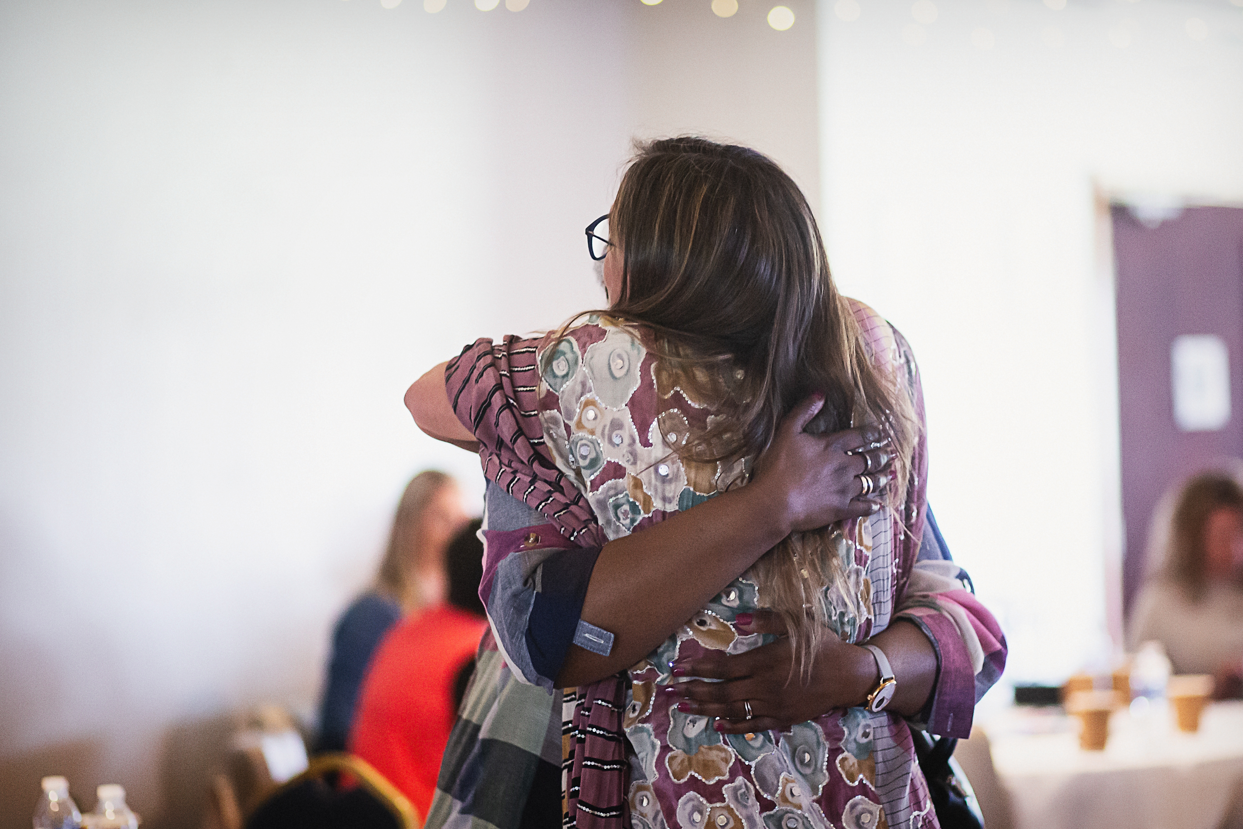 two people with sunrise in background
