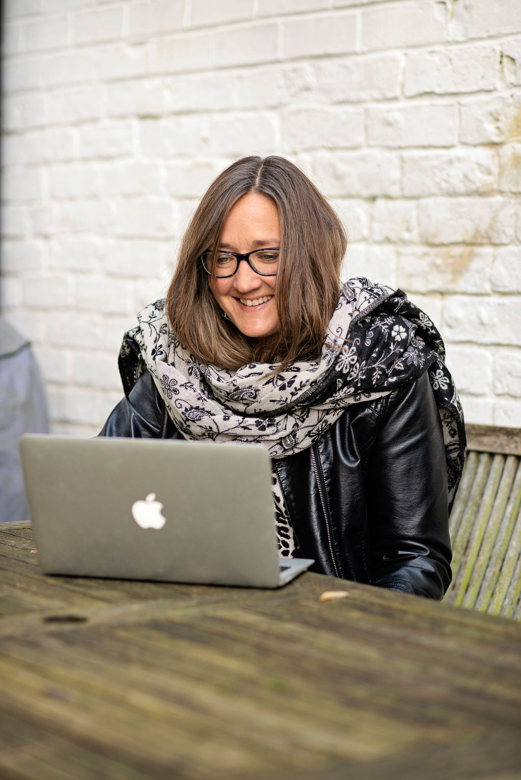 Ali Knight smiling at laptop